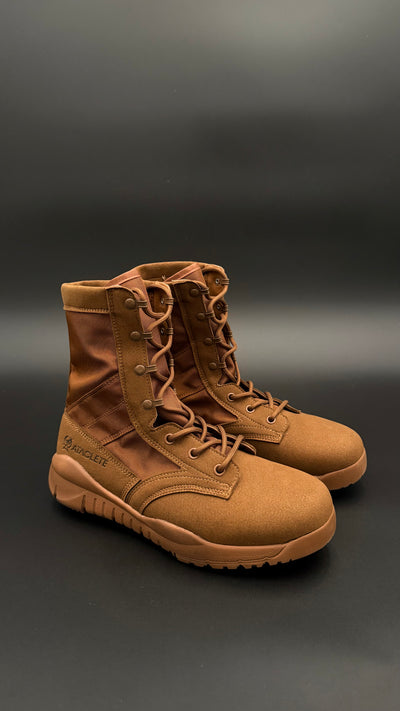 Pair of brown tactical boots on a dark background