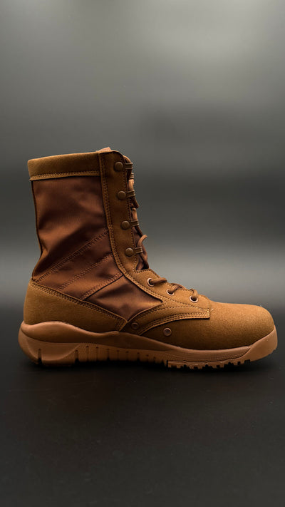 Brown tactical boot on a dark background