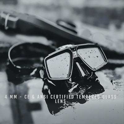 Pair of goggles with tempered glass lenses on a reflective surface